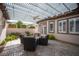Charming outdoor patio area with a pergola, ceiling fan, and stylish wicker seating at 1901 Shady Elm St, Las Vegas, NV 89135