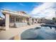 A backyard pool with a covered patio, and comfortable seating, perfect for relaxing outdoors at 1901 Shady Elm St, Las Vegas, NV 89135
