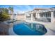 Inviting backyard pool area with a covered patio, outdoor seating, and a basketball hoop at 1901 Shady Elm St, Las Vegas, NV 89135