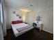 Bright bedroom featuring a vanity and a comfortable bed at 200 N Bruce St # A, Las Vegas, NV 89101