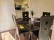 Small dining area with glass table and four black chairs at 200 N Bruce St # A, Las Vegas, NV 89101