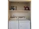 Functional laundry closet with shelving and appliances at 200 N Bruce St # A, Las Vegas, NV 89101