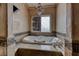 Relaxing bathroom with soaking tub and tiled surround at 2049 Troon Dr, Henderson, NV 89074