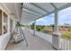 Spacious covered patio with pergola and a swing, offering scenic views at 2049 Troon Dr, Henderson, NV 89074