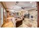 Open living room with hardwood floors, fireplace, and leather seating at 2049 Troon Dr, Henderson, NV 89074