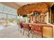 Outdoor tiki bar with seating for entertaining at 2049 Troon Dr, Henderson, NV 89074