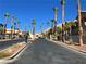 Community entrance with palm trees and mountain view at 2110 Los Feliz St # 1046, Las Vegas, NV 89156