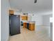 Kitchen with wood cabinets, stainless steel appliances, and tile floor at 2110 Los Feliz St # 1046, Las Vegas, NV 89156