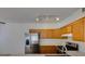 Modern kitchen with stainless steel appliances and light wood cabinets at 2110 Los Feliz St # 1046, Las Vegas, NV 89156