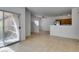 Bright living room with tile floors, sliding door to patio, and access to kitchen at 2110 Los Feliz St # 1046, Las Vegas, NV 89156