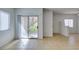 Bright living room with tile floors, sliding door to patio, and access to kitchen at 2110 Los Feliz St # 1046, Las Vegas, NV 89156