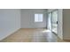 Living room with tile floors, sliding door, and window at 2110 Los Feliz St # 1046, Las Vegas, NV 89156