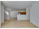 Bright living room with tile floors, kitchen access, and ceiling fan at 2110 Los Feliz St # 1046, Las Vegas, NV 89156