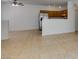Bright living room with tile floors, kitchen access, and ceiling fan at 2110 Los Feliz St # 1046, Las Vegas, NV 89156