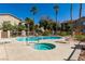 Community pool and spa with lounge chairs at 2110 Los Feliz St # 1046, Las Vegas, NV 89156