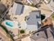 Expansive property featuring a sparkling pool, lush green patches, and a detached garage, captured from an aerial perspective at 2327 River City Dr, Laughlin, NV 89029