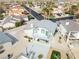 Aerial view of home with a balcony, desert landscaping, and a driveway, surrounded by other homes and palm trees at 2327 River City Dr, Laughlin, NV 89029