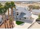 Aerial view showcases the home and the yard with lush palm trees enhancing curb appeal at 2327 River City Dr, Laughlin, NV 89029