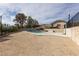 View of the pool area with low desert landscaping and privacy wall at 2327 River City Dr, Laughlin, NV 89029