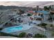 Aerial view showcases the backyard with a private pool and outdoor dining area, perfect for entertaining at 2327 River City Dr, Laughlin, NV 89029
