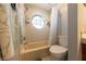 Bathroom with a unique round window above the bathtub with a shower at 2327 River City Dr, Laughlin, NV 89029