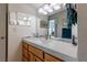 Modern bathroom with a wooden vanity, updated lighting, and tiled backsplash at 2327 River City Dr, Laughlin, NV 89029