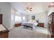 Spacious bedroom featuring neutral carpet, natural lighting and a ceiling fan at 2327 River City Dr, Laughlin, NV 89029