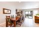 Dining room features a wood table, seating for eight, sliding glass doors to backyard, and tile floors at 2327 River City Dr, Laughlin, NV 89029