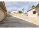 Long driveway leading to a detached garage and home with desert landscaping at 2327 River City Dr, Laughlin, NV 89029