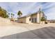 Exterior view of the home showcasing desert landscaping and a long driveway at 2327 River City Dr, Laughlin, NV 89029
