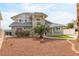 Home featuring desert landscaping, neutral color scheme, tile roof, and a private gated entrance at 2327 River City Dr, Laughlin, NV 89029