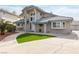 Home featuring desert landscaping, circular driveway, neutral color scheme, and a private gated entrance at 2327 River City Dr, Laughlin, NV 89029