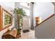 Bright foyer with tile flooring, a decorative mirror, staircase, and a charming potted tree that accents the front door at 2327 River City Dr, Laughlin, NV 89029