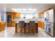 Bright kitchen features a center island with seating, stainless steel appliances, and a window over the sink at 2327 River City Dr, Laughlin, NV 89029
