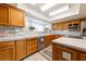Well-lit kitchen featuring oak cabinetry, a stylish backsplash, stainless steel appliances, and a large window at 2327 River City Dr, Laughlin, NV 89029