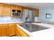 Bright kitchen with stainless steel appliances, white countertops, light wood cabinets, and open layout at 2327 River City Dr, Laughlin, NV 89029