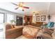 Cozy living room with fireplace, comfortable seating, ceiling fans, and lots of natural light at 2327 River City Dr, Laughlin, NV 89029
