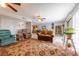 Comfortable living room with fireplace, plush seating, area rug, and access to the dining room at 2327 River City Dr, Laughlin, NV 89029