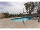 View of the pool area with desert landscaping and mature trees at 2327 River City Dr, Laughlin, NV 89029