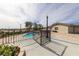 View of the gated pool area with desert landscaping and clear blue skies at 2327 River City Dr, Laughlin, NV 89029