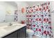 Well-lit bathroom featuring a vanity with a sink and a floral shower curtain at 3558 Herodain Ave, Las Vegas, NV 89106