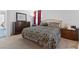 Bright bedroom featuring a patterned bedspread, dresser, and red curtains at 3558 Herodain Ave, Las Vegas, NV 89106