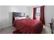 Cozy bedroom with a patterned red comforter and a large window at 3558 Herodain Ave, Las Vegas, NV 89106