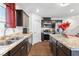 Stylish kitchen features granite countertops, stainless appliances, and dark cabinetry at 3558 Herodain Ave, Las Vegas, NV 89106