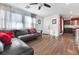 Open-concept living room featuring hardwood floors and a comfortable leather sofa at 3558 Herodain Ave, Las Vegas, NV 89106