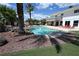 Inviting backyard oasis featuring a sparkling pool, lounge chairs, and lush landscaping at 4193 W Warm Springs Rd, Las Vegas, NV 89118