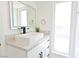 Bright bathroom featuring a stylish vessel sink, quartz countertop, and a framed mirror at 4193 W Warm Springs Rd, Las Vegas, NV 89118