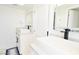 Bright bathroom featuring dual vessel sinks, modern fixtures, and clean white cabinets against white walls at 4193 W Warm Springs Rd, Las Vegas, NV 89118