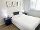 Bedroom with a queen bed, modern headboard, bedside tables, and window with blinds at 4193 W Warm Springs Rd, Las Vegas, NV 89118