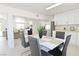 Open-concept dining area with a modern table set, connecting to a bright, fully-equipped kitchen at 4193 W Warm Springs Rd, Las Vegas, NV 89118